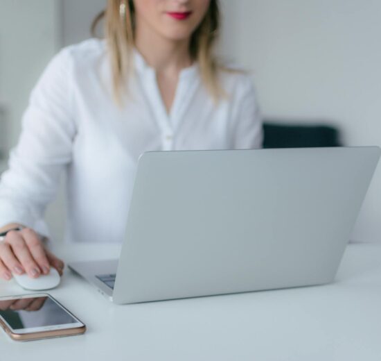 woman using silver laptop